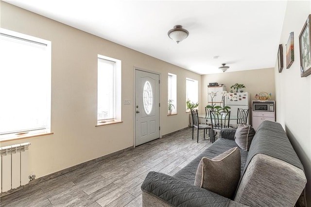 interior space featuring hardwood / wood-style flooring and radiator