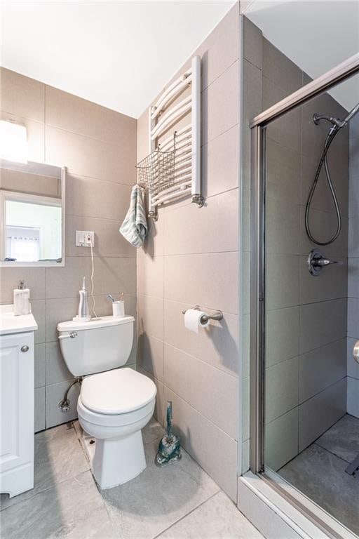 bathroom featuring an enclosed shower, tile patterned floors, toilet, and radiator