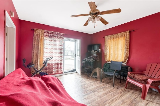 bedroom featuring access to exterior, ceiling fan, and hardwood / wood-style flooring