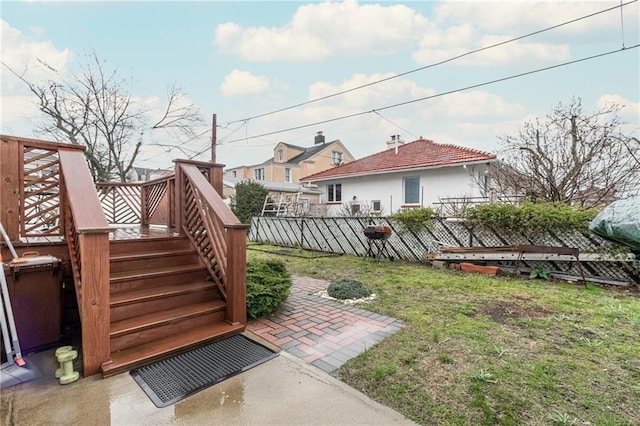 view of yard featuring a deck and a patio area