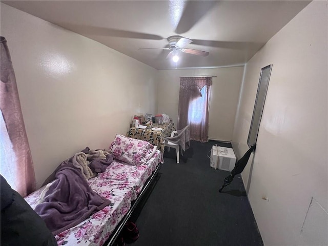 bedroom featuring ceiling fan and carpet