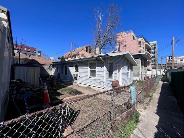 back of house featuring cooling unit