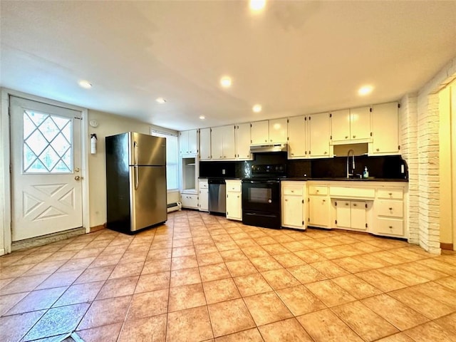 kitchen with tasteful backsplash, sink, white cabinets, and appliances with stainless steel finishes