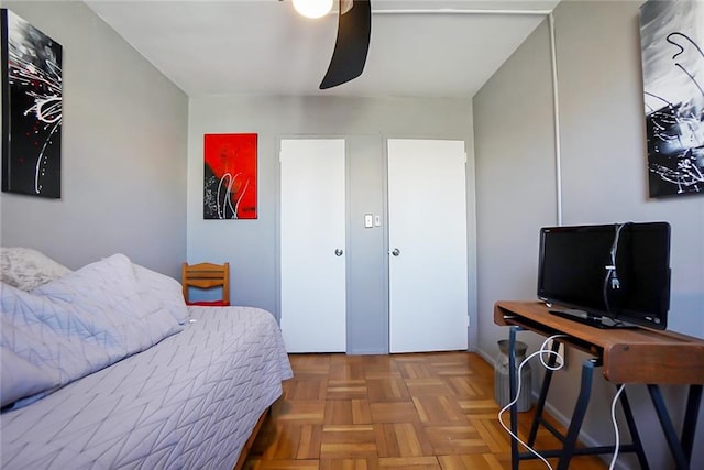 bedroom featuring parquet floors and ceiling fan