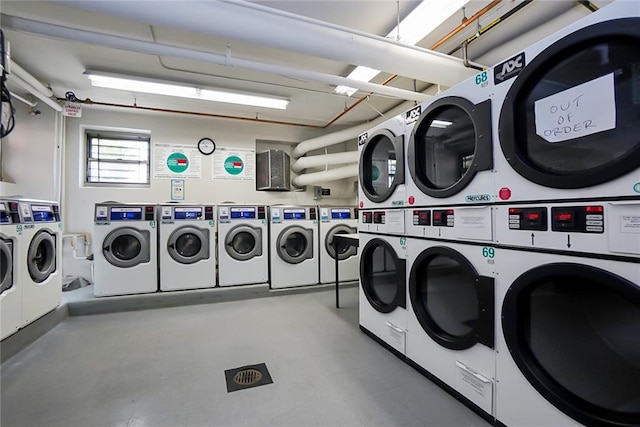 laundry room with stacked washer / drying machine and washer and clothes dryer