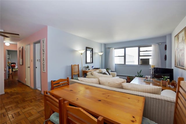 living room with cooling unit, ceiling fan, and dark parquet floors