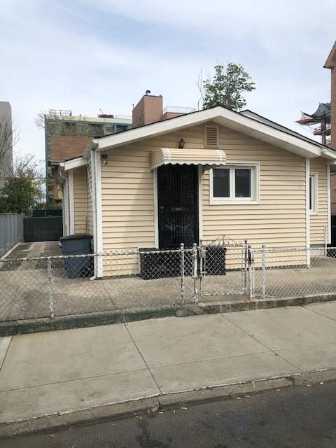 view of front facade with a fenced front yard and a chimney