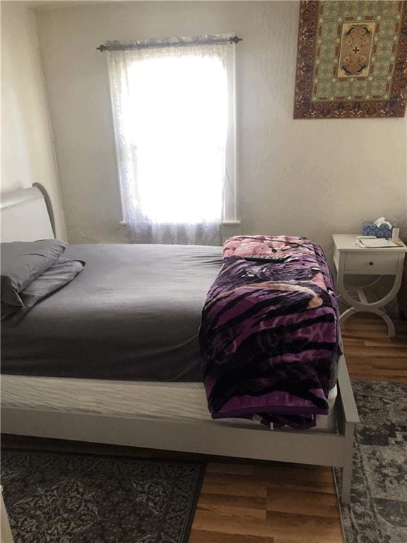 bedroom featuring wood finished floors