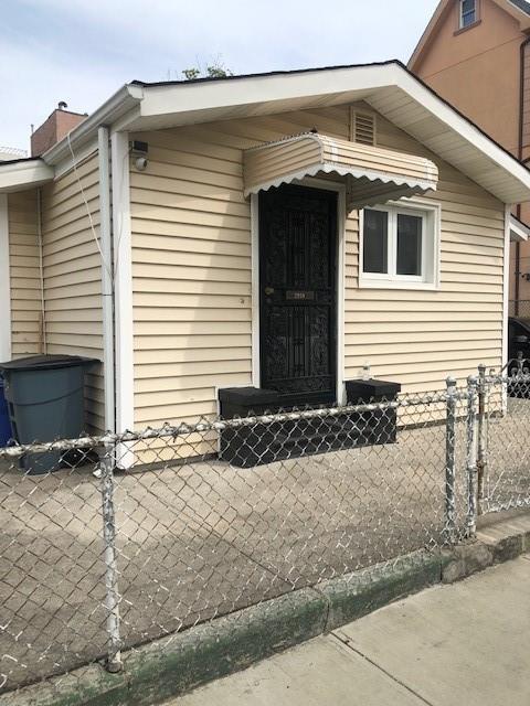 property entrance with a chimney and fence