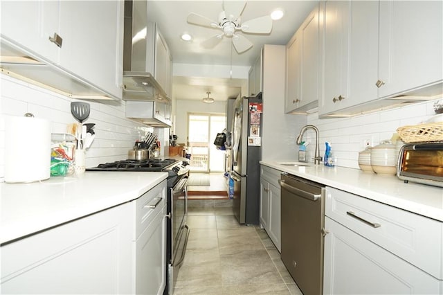 kitchen with white cabinetry, sink, wall chimney exhaust hood, and appliances with stainless steel finishes