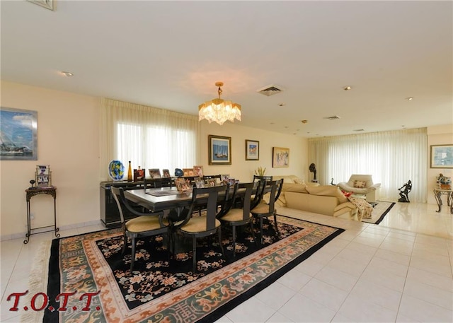 tiled dining space featuring a chandelier