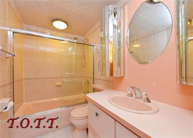 full bathroom featuring toilet, enclosed tub / shower combo, tile patterned floors, and vanity