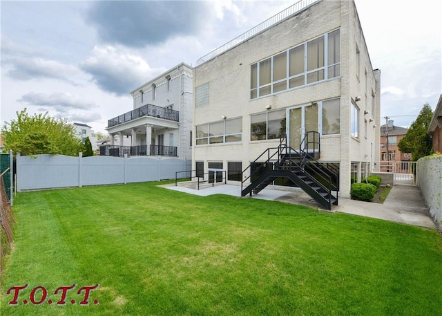 back of house featuring a lawn and a patio