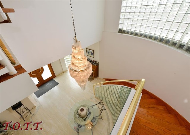 stairway featuring a chandelier