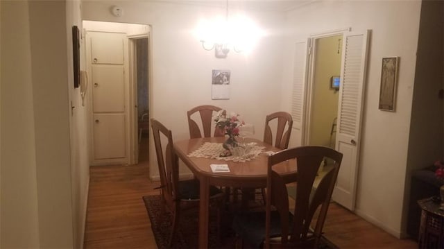 dining area with dark wood-style floors and baseboards