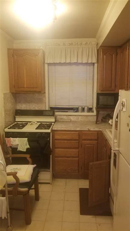 kitchen with ornamental molding, light countertops, white appliances, and backsplash