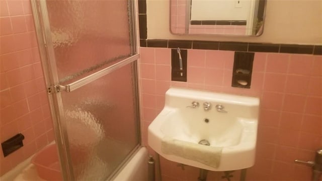 full bathroom featuring enclosed tub / shower combo and tile walls