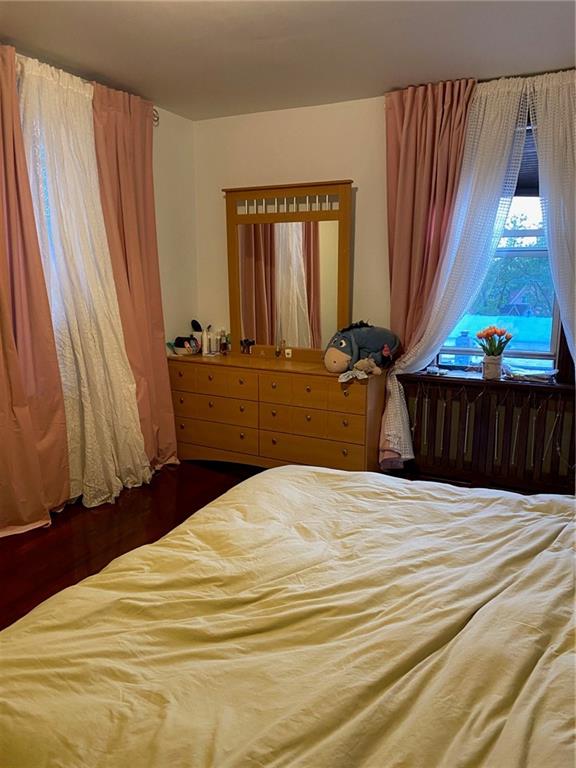 bedroom with dark hardwood / wood-style floors