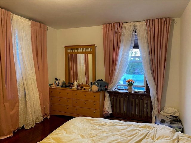 bedroom with dark wood-type flooring