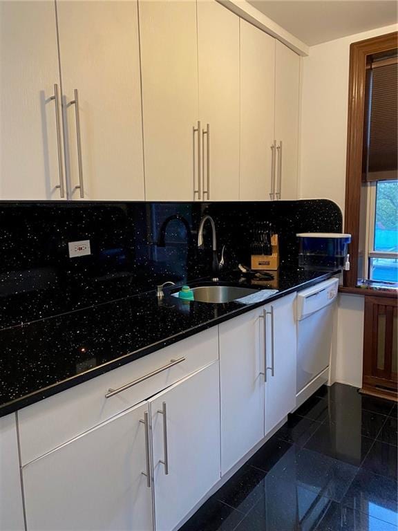 kitchen with sink, dishwasher, tasteful backsplash, white cabinets, and dark stone counters