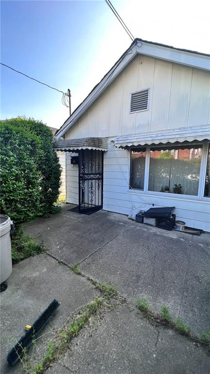 view of side of property featuring a patio area