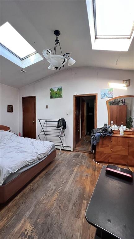 bedroom with lofted ceiling with skylight and wood finished floors