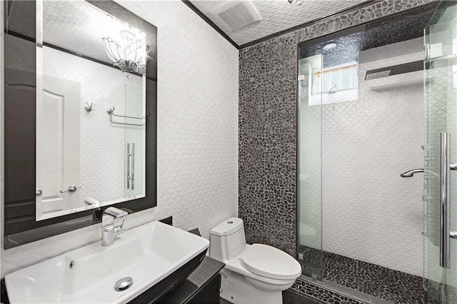 bathroom with walk in shower, vanity, and toilet