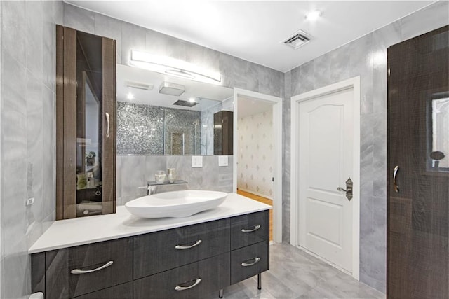 bathroom with vanity, tile walls, and an enclosed shower