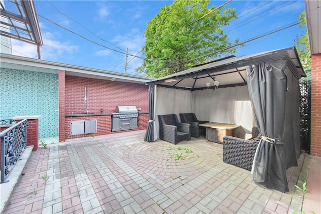 view of patio / terrace with a gazebo, area for grilling, a grill, and outdoor lounge area