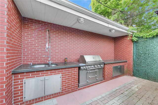 view of patio featuring exterior kitchen, sink, and grilling area