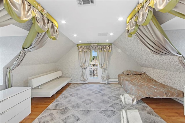 bedroom featuring hardwood / wood-style flooring and lofted ceiling