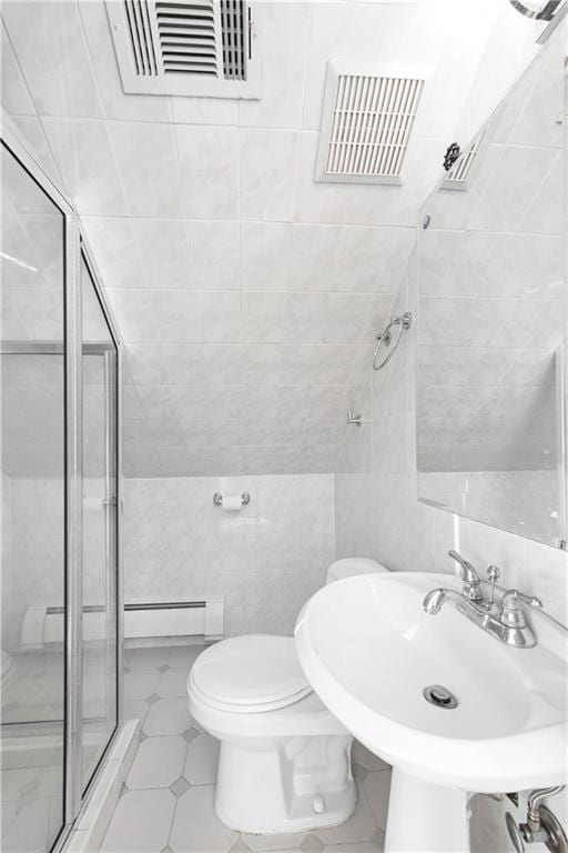 bathroom featuring toilet, an enclosed shower, sink, tile walls, and a baseboard heating unit