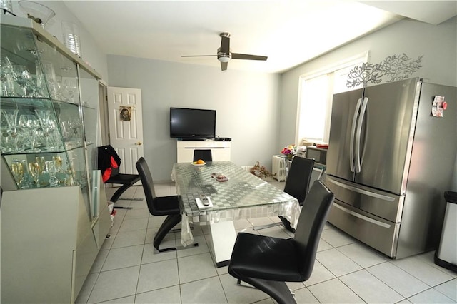 tiled dining area with ceiling fan