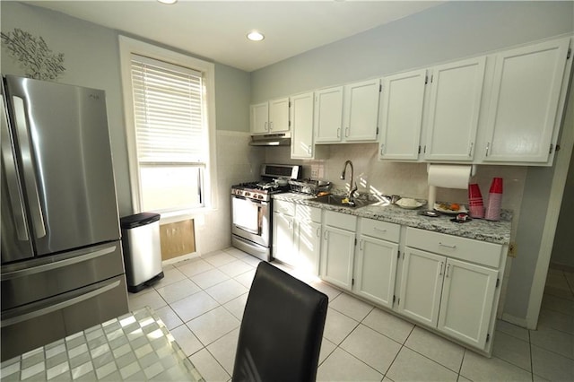 kitchen featuring white cabinetry, stainless steel appliances, sink, and light tile floors