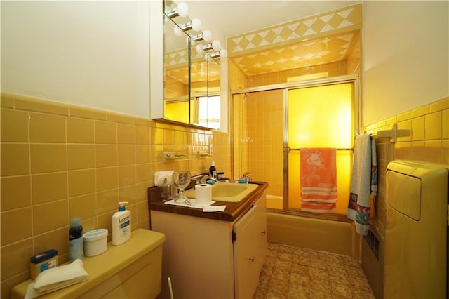 full bathroom with tile walls, backsplash, toilet, and vanity