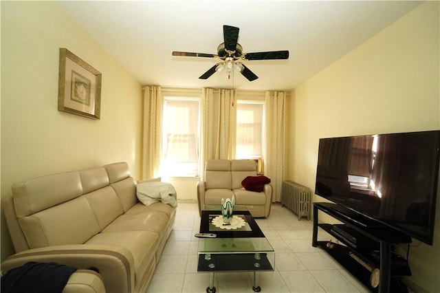 living room with ceiling fan, light tile floors, and radiator heating unit