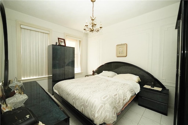 tiled bedroom with a chandelier