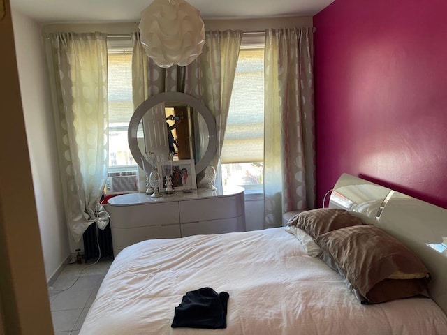 bedroom featuring tile flooring and multiple windows