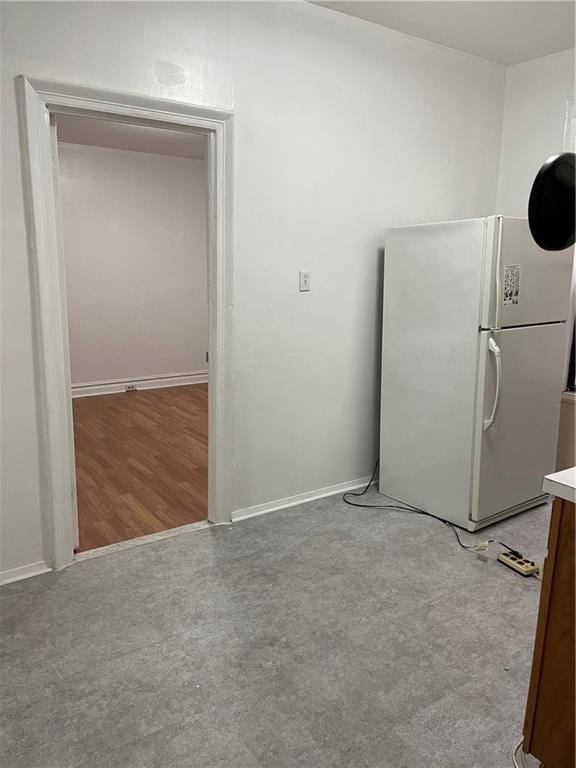 kitchen featuring white refrigerator and hardwood / wood-style floors