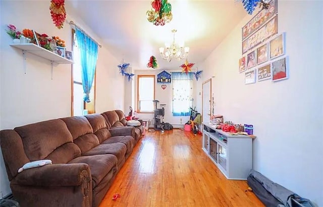 living area with a chandelier and wood finished floors