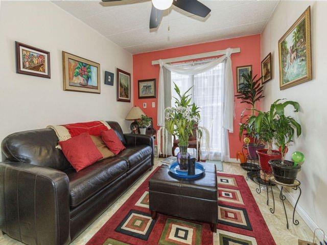 living room with ceiling fan and a wealth of natural light