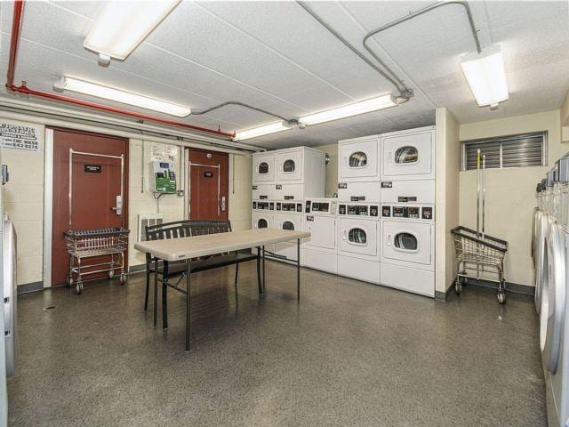 interior space featuring stacked washing maching and dryer