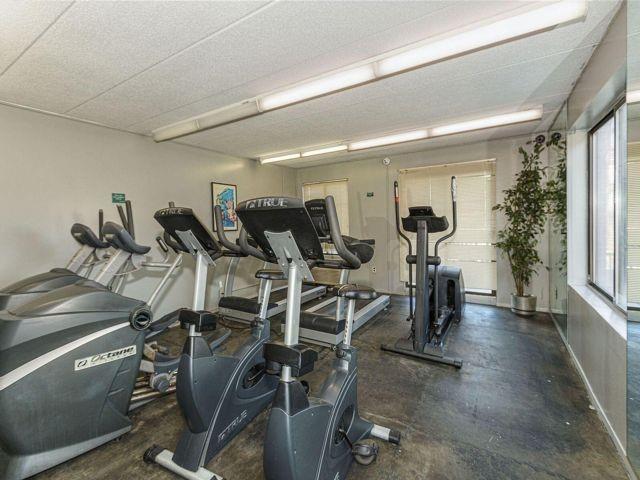 workout area featuring a baseboard heating unit