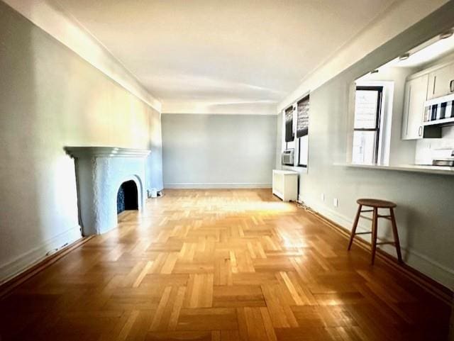 8020 4th Ave Unit D5, Brooklyn, NY 11209 - unfurnished living room featuring baseboards, radiator, and a fireplace