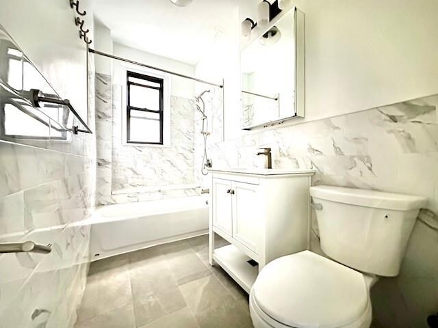 8020 4th Ave Unit D5, Brooklyn, NY 11209 - bathroom with shower / washtub combination, vanity, toilet, and tile walls
