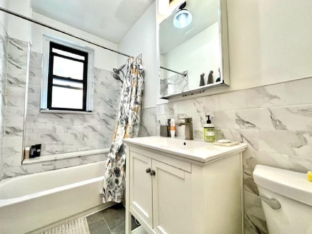 8020 4th Ave Unit D5, Brooklyn, NY 11209 - full bath with vanity, tile walls, shower / bath combo with shower curtain, and toilet