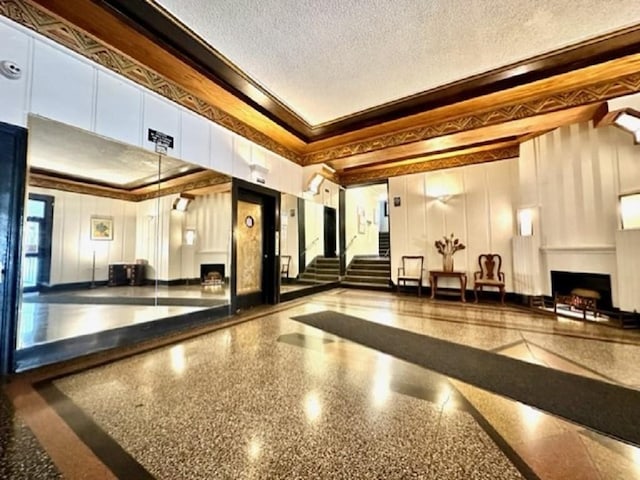 8020 4th Ave Unit D5, Brooklyn, NY 11209 - common area with crown molding, a decorative wall, stairway, a textured ceiling, and a towering ceiling
