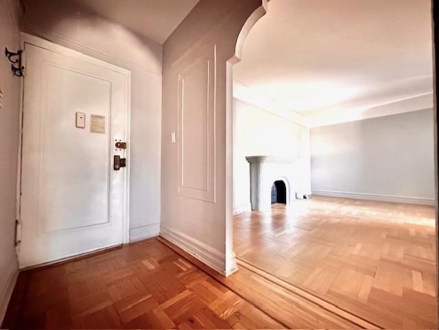8020 4th Ave Unit D5, Brooklyn, NY 11209 - foyer with baseboards and a fireplace