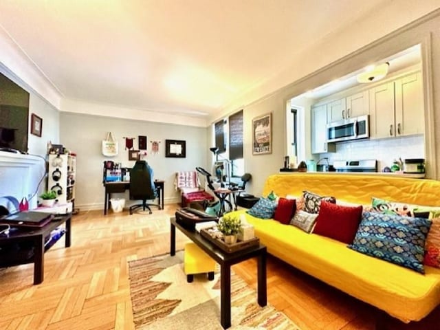 8020 4th Ave Unit D5, Brooklyn, NY 11209 - living area with a desk, ornamental molding, and baseboards