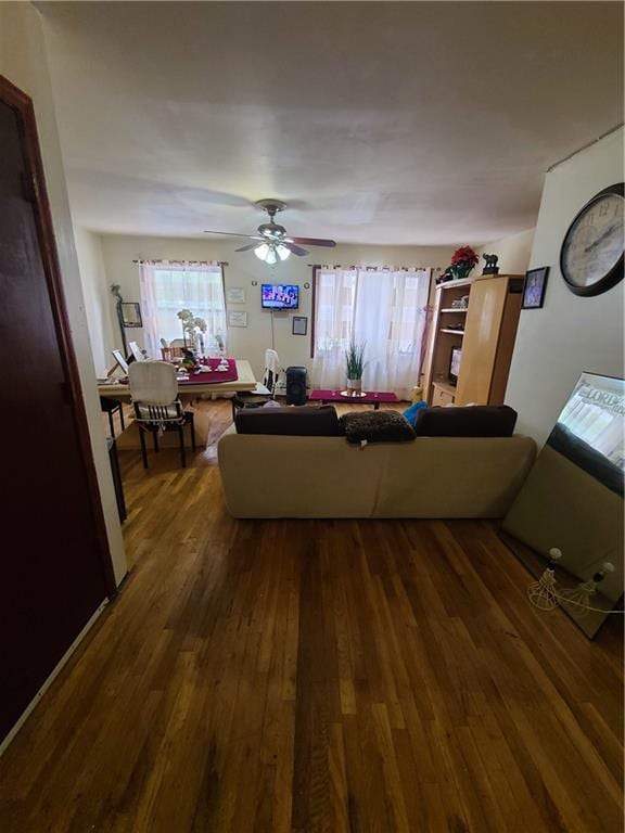 unfurnished living room with dark hardwood / wood-style floors and ceiling fan